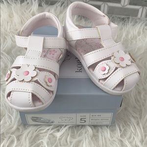 White and pink koala sandals.